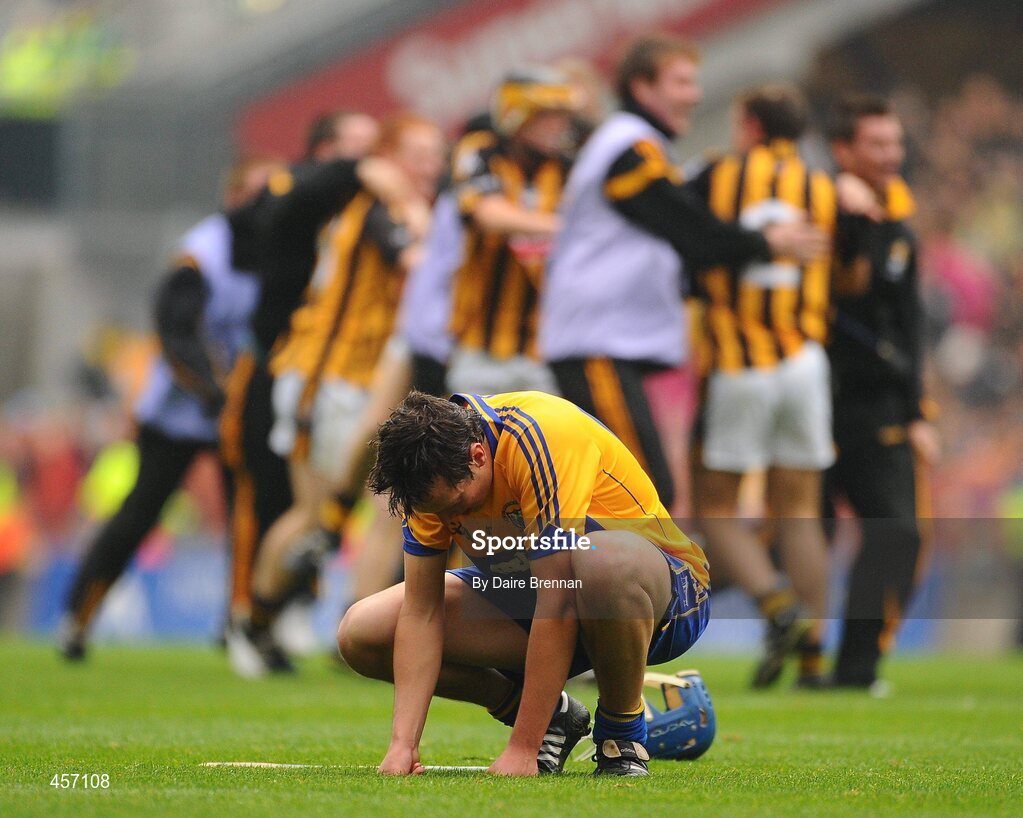 5 September 2010; A dejected Daire Keane, Clare, sits on the pitch after the game as the Kilkenny players celebrate behind him. ESB GAA Hurling All-Ireland Minor Championship Final, Kilkenny v Clare, Croke Park, Dublin. Picture credit: Dáire Brennan / SPORTSFILE