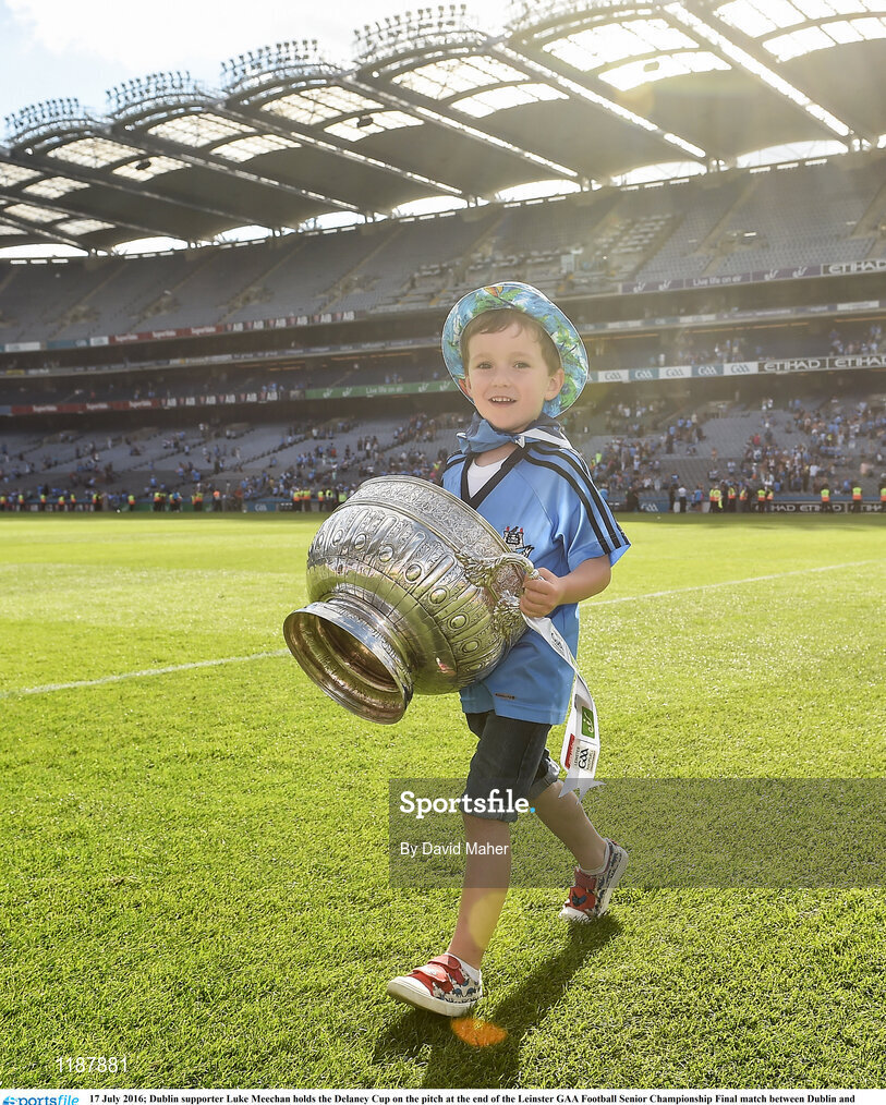 17 July 2016; Dublin supporter Luke Meechan holds the Delaney Cup on the pitch at the end of the Leinster GAA Football Senior Championship Final match between Dublin and Westmeath at Croke Park in Dubin. Photo by David Maher/Sportsfile