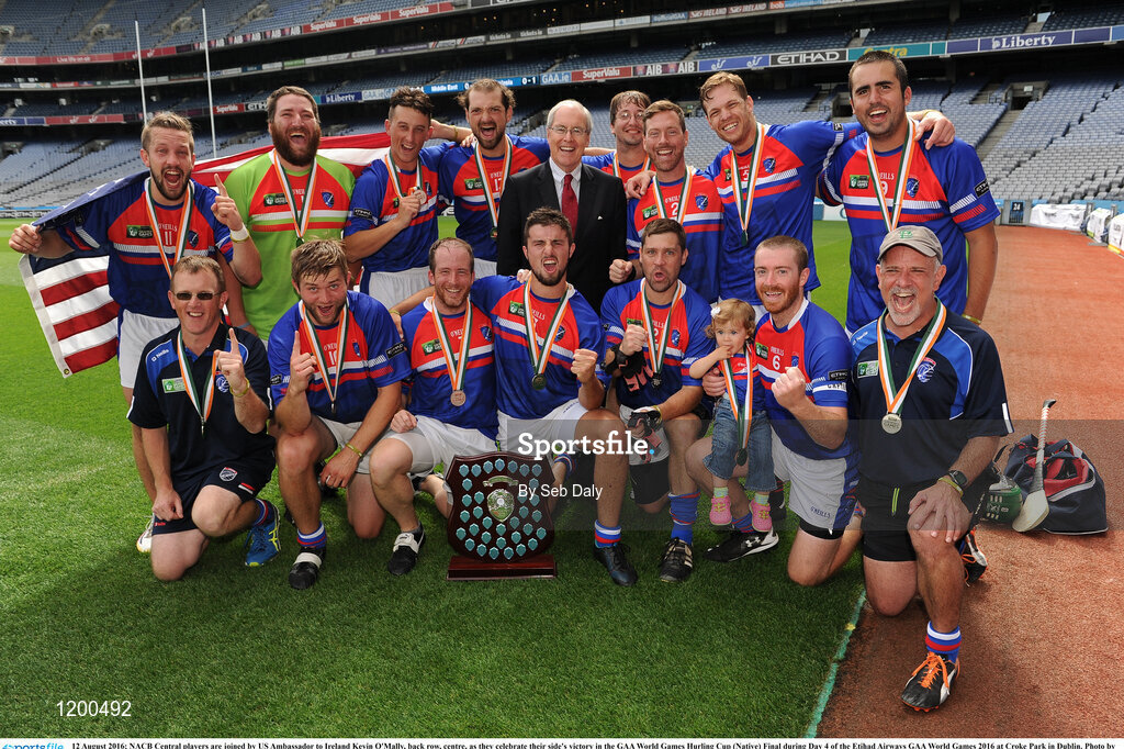 12 August 2016; NACB Central players are joined by US Ambassador to Ireland Kevin O'Mally, back row, centre, as they celebrate their side's victory in the GAA World Games Hurling Cup (Native) Final during Day 4 of the Etihad Airways GAA World Games 2016 at Croke Park in Dublin. Photo by Seb Daly/Sportsfile