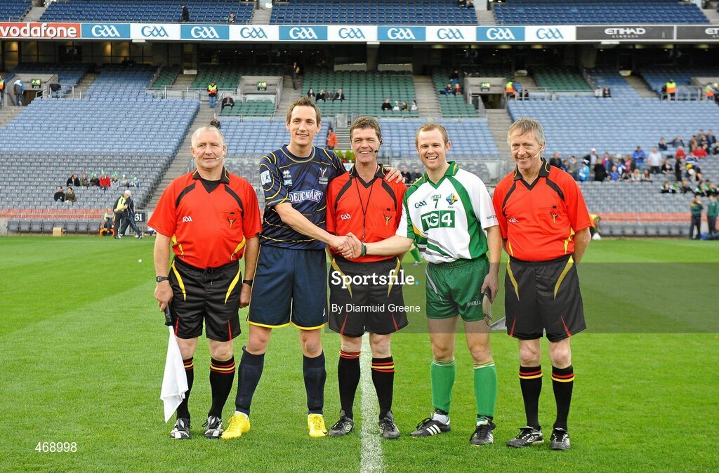 30 October 2010; Scotland captain Gary Innes and Ireland captain Tommy Walsh with referee Tony Carroll, centre and linesmen Ger Devlin, left, and Denis Richardson. Senior Hurling / Shinty International 1st Test, Ireland v Scotland, Croke Park, Dublin. Picture credit: Diarmuid Greene / SPORTSFILE