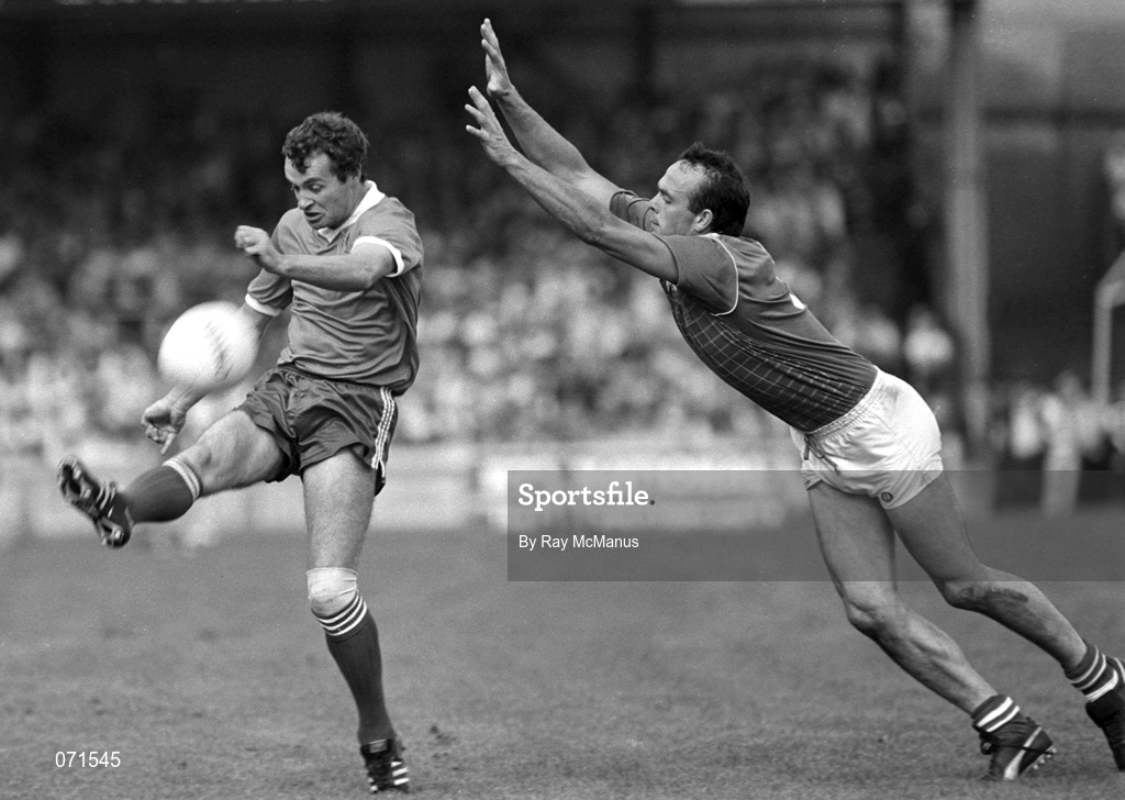 24 August 1986; Mikey Sheehy of Kerry scores a point despite the attention of Mick Lyons of Meath during the All-Ireland Senior Football Championship Semi-Final match between Meath and Kerry at Croke Park in Dublin. Photo by Ray McManus/Sportsfile