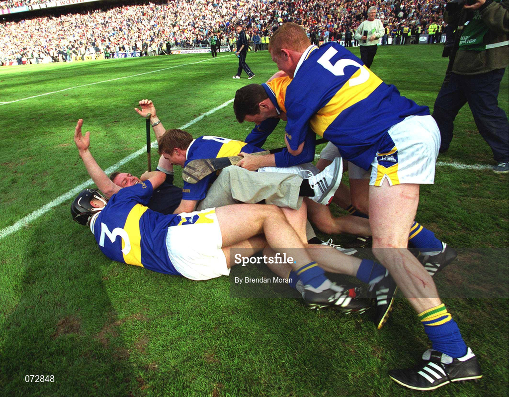 9 September 2001; Tipperary players, from left, Philip Maher, Paul Ormonde, goalkeeper Brendan Cummins and Eamonn Corcoran celebrate with their manager Nicky English following their victory in the Guinness All-Ireland Senior Hurling Championship Final match between Tipperary and Galway at Croke Park in Dublin. Photo by Brendan Moran/Sportsfile