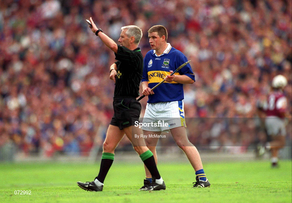 9 September 2001; Referee Pat O'Connor signals for assistance for John Carroll of Tipperary after he received a blood injury during the Guinness All-Ireland Senior Hurling Championship Final match between Tipperary and Galway at Croke Park in Dublin. Photo by Ray McManus/Sportsfile