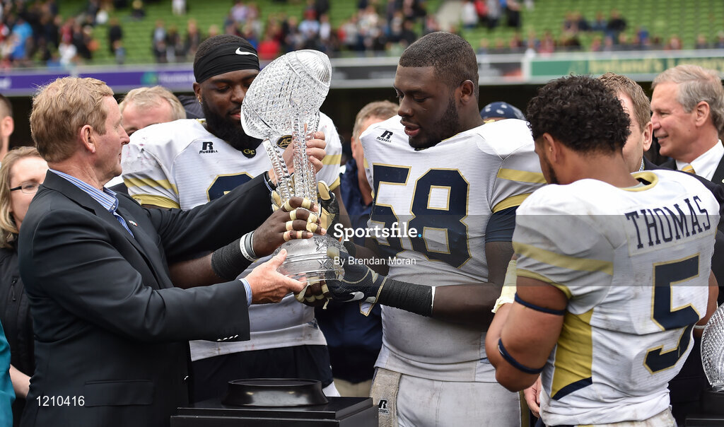 3 September 2016; Defensive Lineman Patrick Gamble (C) and Offensive Lineman Freddie Burden of Georgia Tech Yellow Jackets receive the trophy from An Taoiseach Enda Kenny T.D., after the Aer Lingus College Football Classic match between Boston College Eagles and Georgia Tech Yellow Jackets at the Aviva Stadium in Lansdowne Road, Dublin. Photo by Brendan Moran/Sportsfile