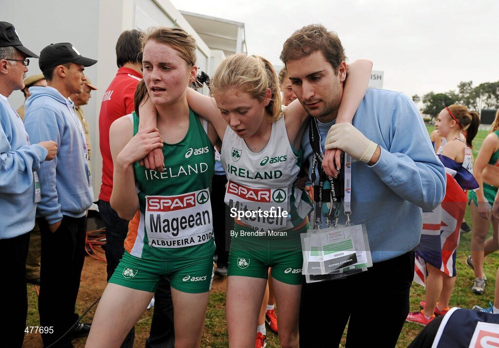 12 December 2010; Ciara Mageean, Ireland, helps team-mate Emma Mitchell after the Women's Junior race. 17th SPAR European Cross Country Championships, Albufeira, Portugal. Picture credit: Brendan Moran / SPORTSFILE