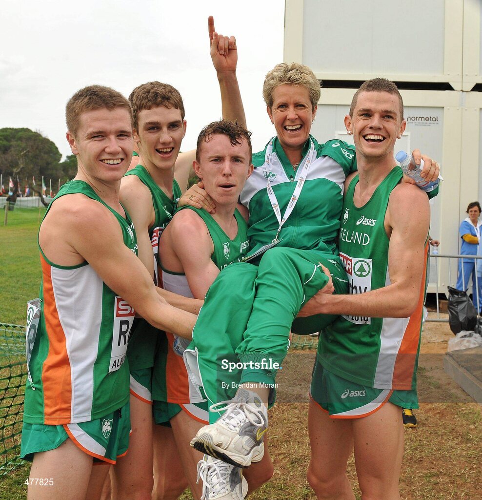 12 December 2010; Ireland U23 men's team, from left, David Rooney, Michael Mulhare, Brendan O'Neill and David McCarthy lift team manager Ann Keenan Buckley after they had secured the team gold medal. 17th SPAR European Cross Country Championships, Albufeira, Portugal. Picture credit: Brendan Moran / SPORTSFILE