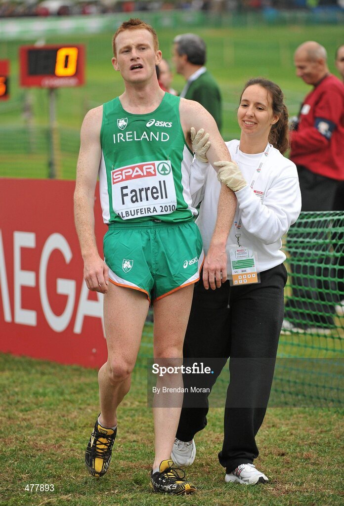12 December 2010; Ireland's Brian Farrell is helped by a volunteer after finishing in 62nd place in the Senior Men's race with a time of 31:59. 17th SPAR European Cross Country Championships, Albufeira, Portugal. Picture credit: Brendan Moran / SPORTSFILE