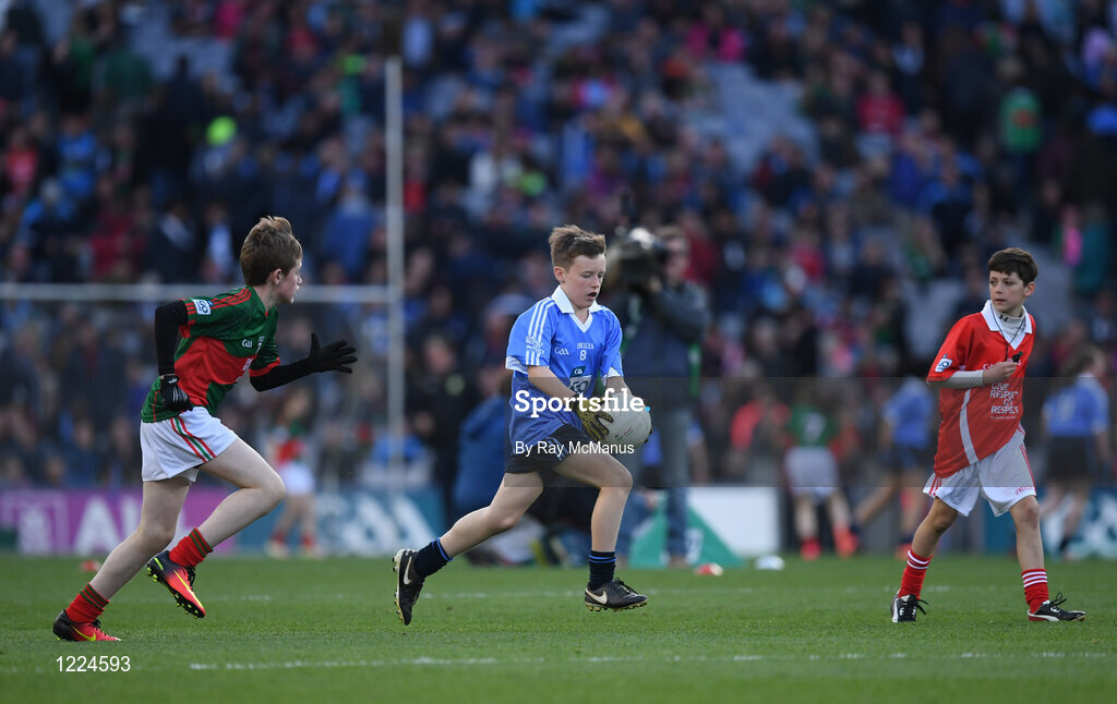 1 October 2016; Referee Fionn Morna, from the Downs NS, Mullingar, Westmeath, looks on as Seán Horan, Hollypark BNS, Blackrock, Dublin, runs past Ian Lavelle, Bohola NS, Bohola, Mayo, during the INTO Cumann na mBunscol GAA Respect Exhibition Go Games at the GAA Football All-Ireland Senior Championship Final Replay match between Dublin and Mayo at Croke Park in Dublin. Photo by Ray McManus/Sportsfile