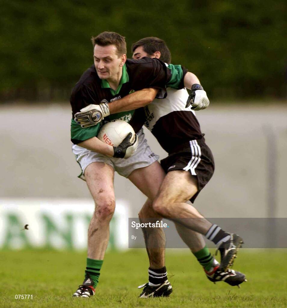 27 October 2001; Kevin Cahill, Nemo Rangers, is tackled by Padraig Conway, Doonbeg. Nemo Rangers v Doonbeg, AIB Munster Club Football Championship, Pairc Ui Rinn, Cork. Picture credit; Brendan Moran / SPORTSFILE *EDI*