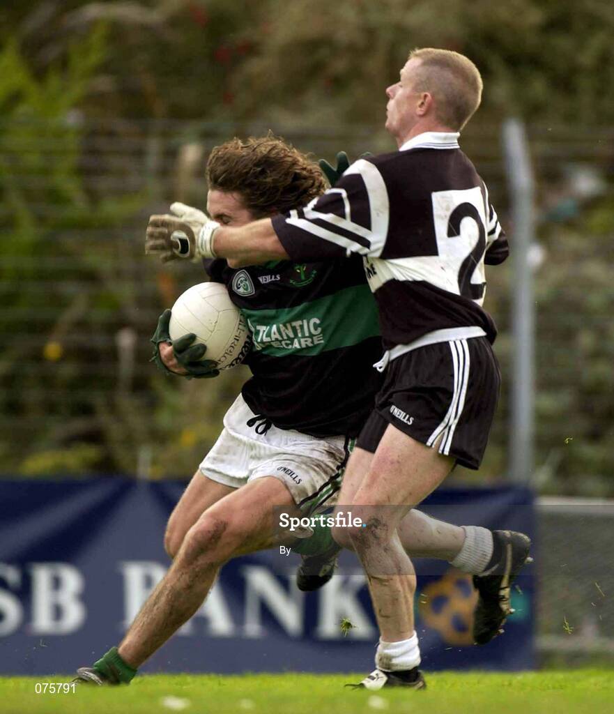 27 October 2001; Alan Cronin, Nemo Rangers, holds off the challenge of Declan Griffin, Doonbeg. Nemo Rangers v Doonbeg, AIB Munster Club Football Championship, Pairc Ui Rinn, Cork. Picture credit; Brendan Moran / SPORTSFILE *EDI*