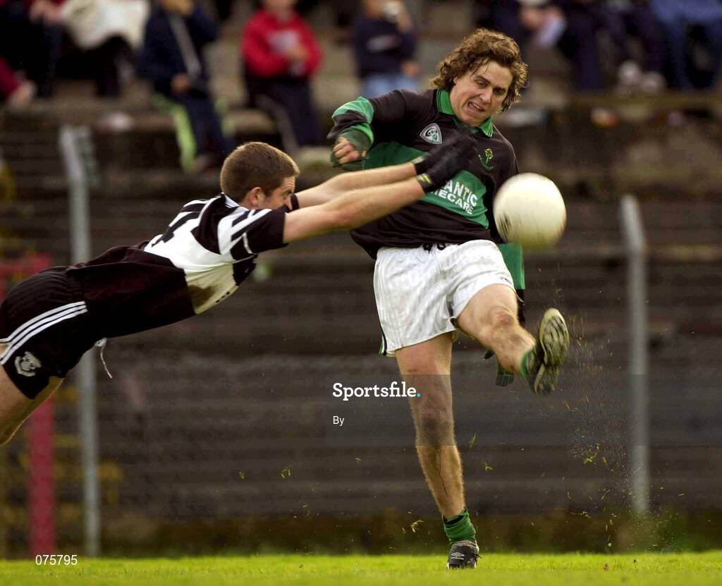 27 October 2001; Alan Cronin, Nemo Rangers, gets his shot off despite the attempted blockdown by Kevin Nugent, Doonbeg. Nemo Rangers v Doonbeg, AIB Munster Club Football Championship, Pairc Ui Rinn, Cork. Picture credit; Brendan Moran / SPORTSFILE *EDI*