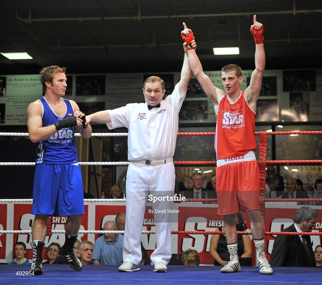 25 February 2011;  Ross Hickey, right Grangecon boxing club, celebrates victory over Philip Sutcliffe, Crumlin boxing Club, in the 64kg division bout. National Boxing Championship Finals, National Stadium, Dublin. Picture credit: David Maher / SPORTSFILE