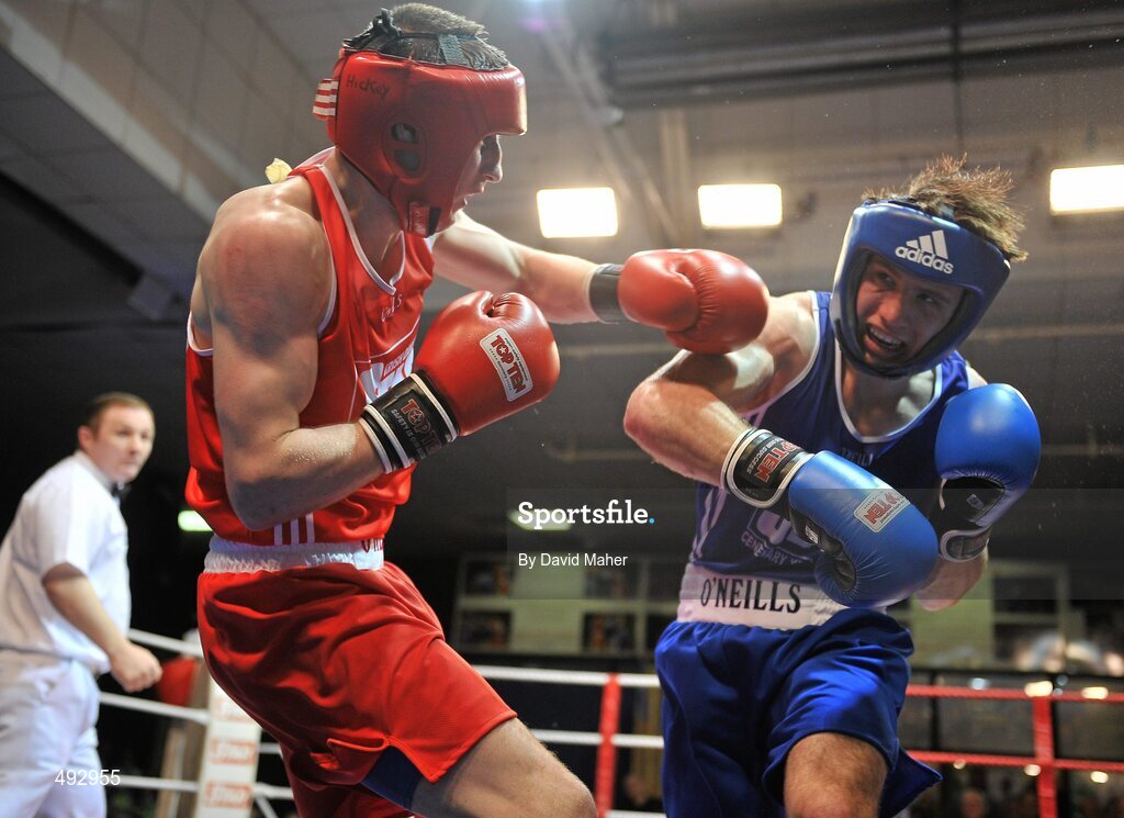 25 February 2011; Ross Hickey, left, Grangecon boxing club, exchanges punches with Philip Sutcliffe, Crumlin boxing Club, Athy, during their 64kg division bout. National Boxing Championship Finals, National Stadium, Dublin. Picture credit: David Maher / SPORTSFILE