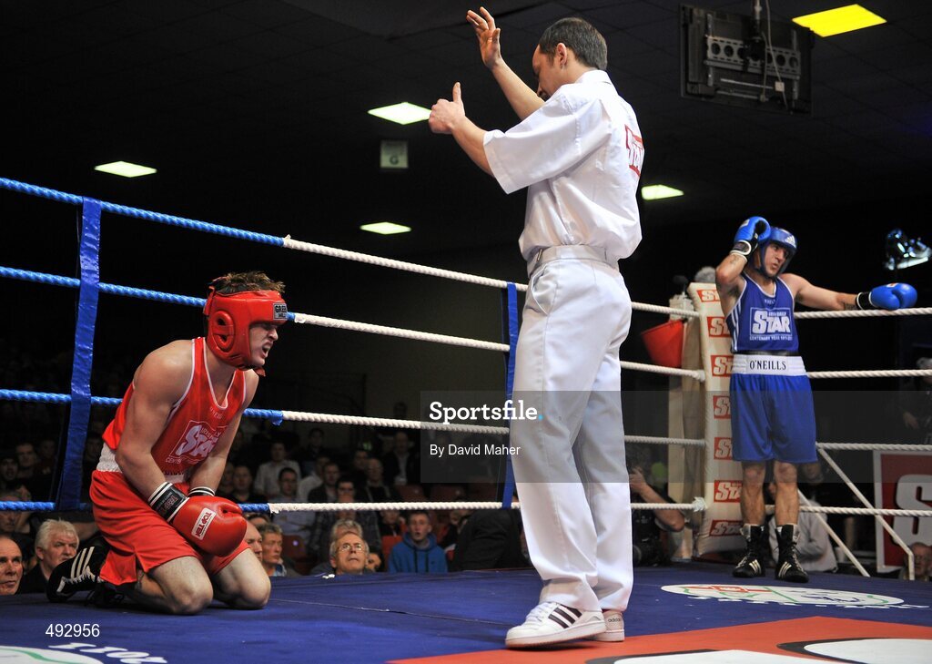 25 February 2011; Michael McDonagh, left, St. Mary's boxing club, is given a count by referee Eugene O'Kane as David Oliver Joyce, St. Michael's boxing Club, Athy, waits in the neutral during the 60kg division bout. National Boxing Championship Finals, National Stadium, Dublin. Picture credit: David Maher / SPORTSFILE