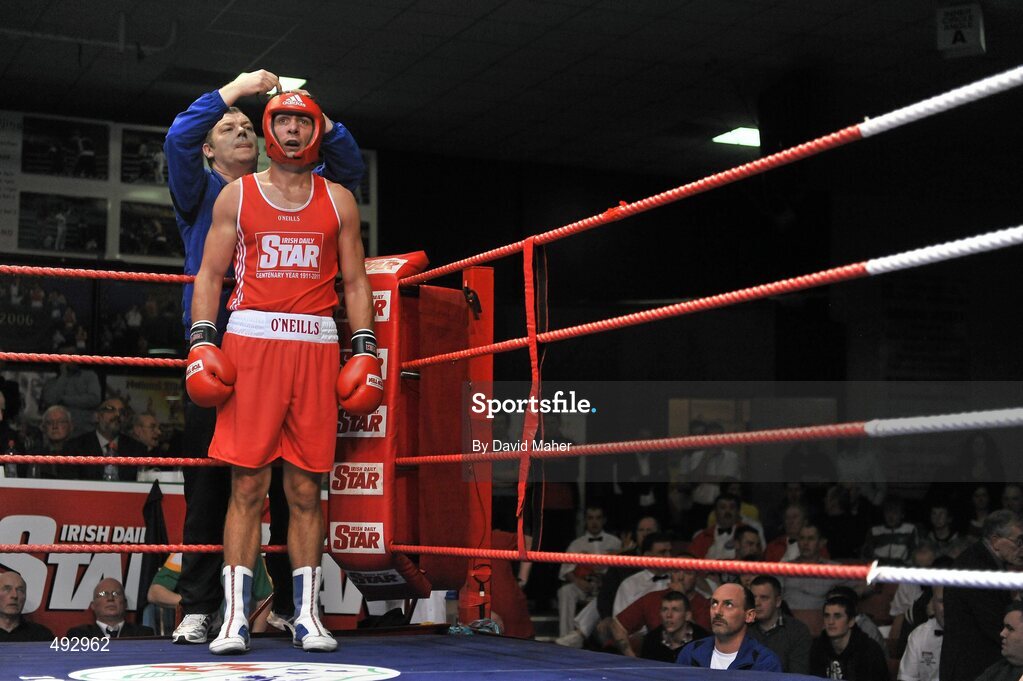 25 February 2011; Kenneth Egan, Neiltowns boxing club, has his head gear tied up by his trainer during the third round against Joe Ward, Moate boxing Club, during their 75kg division bout. National Boxing Championship Finals, National Stadium, Dublin. Picture credit: David Maher / SPORTSFILE