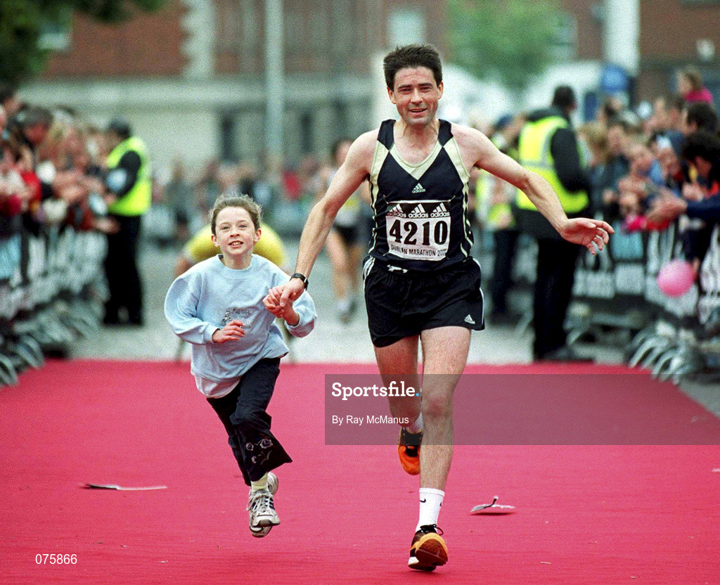 29 October 2001; Jermiah O'Sullivan (4210) and Mary Anne head for the finish line together. adidas Dublin Marathon in Dublin. Photo by Ray McManus/Sportsfile