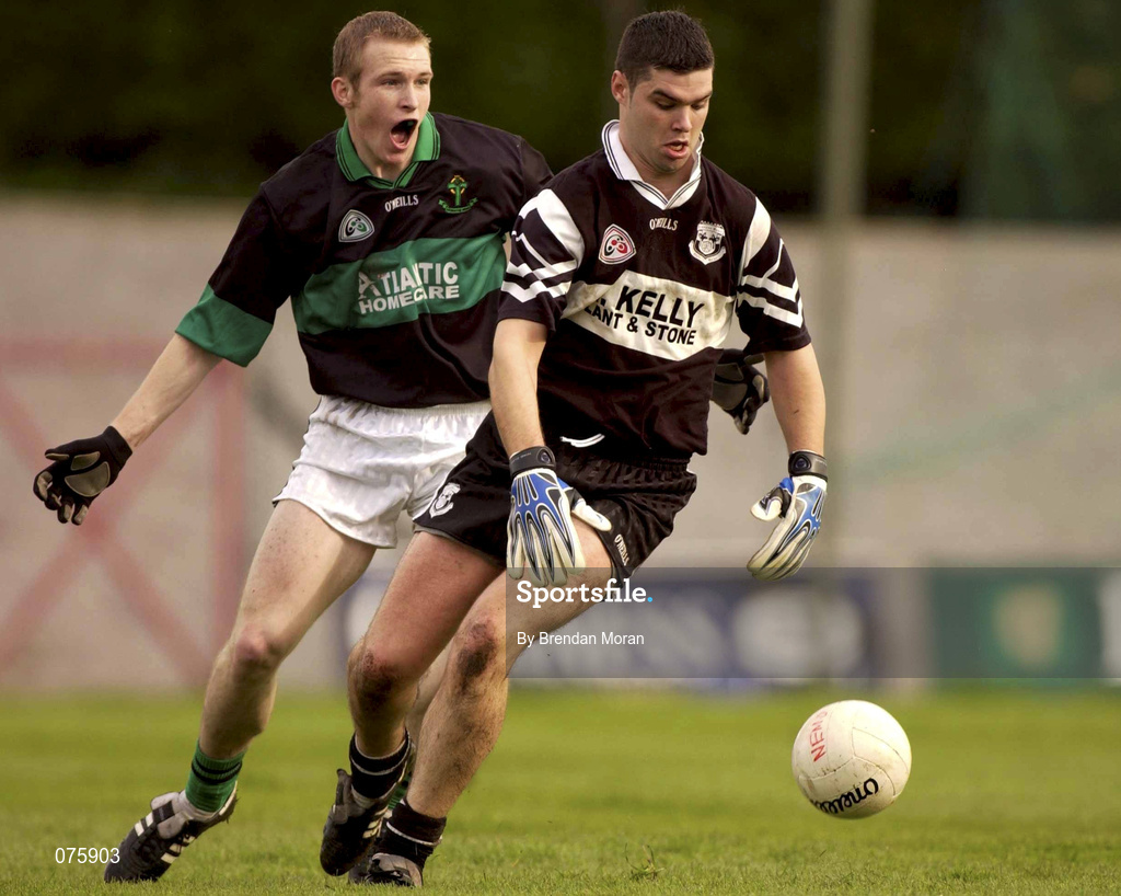 27 October 2001; Paul Hehir of Doonbeg is tackled by Dylan Mehigan of Nemo Rangers during the AIB Munster Senior Club Football Championship Quarter-Final match between Nemo Rangers and Doonbeg at Páirc Uí Rinn in Cork. Photo by Brendan Moran/Sportsfile