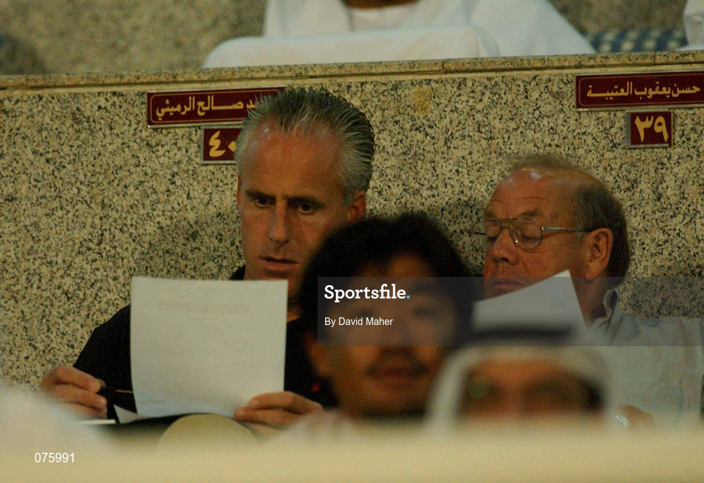 31 October 2001; Republic of Ireland manager, Mick McCarthy, checks his notes alongside Eddie Corcoran, FAI Liason officer, during the 2002 FIFA World Cup AFC Qualification Play-Off 2nd Leg match between United Arab Emirates and Iran the at Al-Nahyan Stadium in Abu Dhabi, United Arab Emirates. Photo by David Maher/Sportsfile