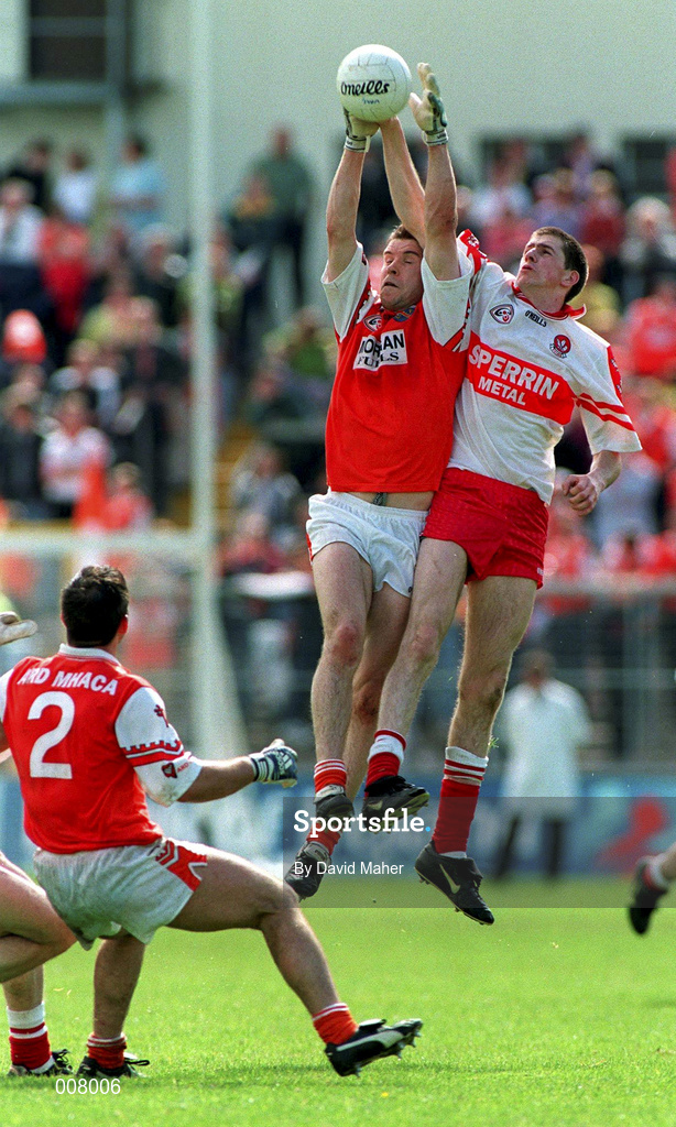 28 June 1998; Enda Muldoon Derry in action against Paul McGrane Armagh during the Bank of Ireland Ulster Senior Football Championship Semi-Final match between Armagh and Derry at St Tiernach's Park in Clones, Monaghan. Photo by David Maher/Sportsfile
