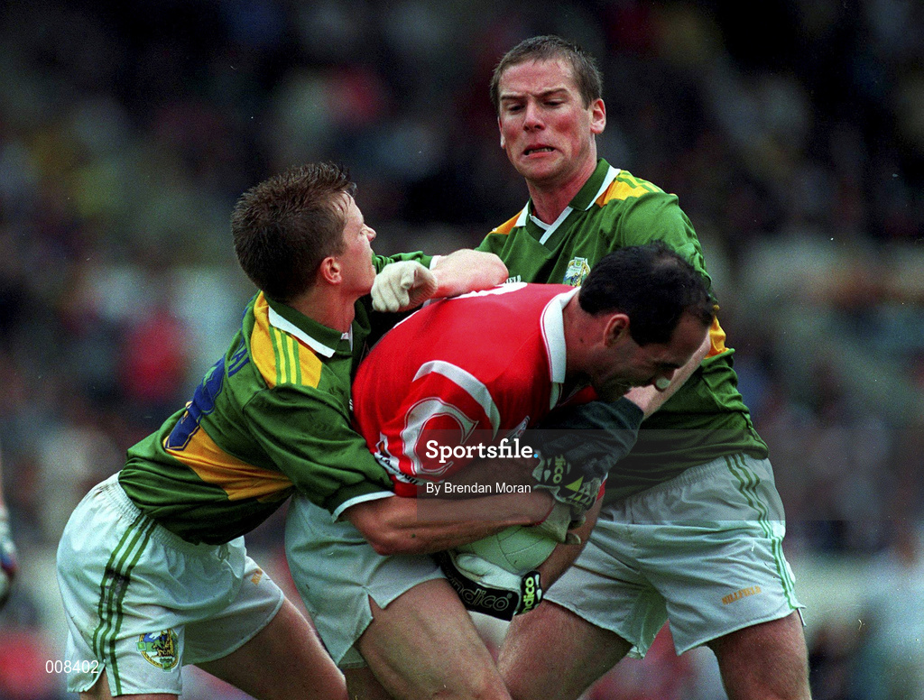 21 July 1996; Mark O'Connor of Cork in action against Geni Farrell, 13, and and Dara Ó Cinnéide of Kerry during the Bank of Ireland Munster Senior Football Championship Final match between Cork and Kerry at Páirc Uí Chaoimh in Cork. Photo by Brendan Moran/Sportsfile