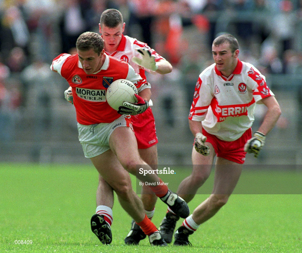 28 June 1998; John McEnteey of Armagh is tackled by Dermot Dougan of Derry during the Bank of Ireland Ulster Senior Football Championship Semi-Final match between Armagh and Derry at St Tiernach's Park in Clones, Monaghan. Photo by David Maher/Sportsfile