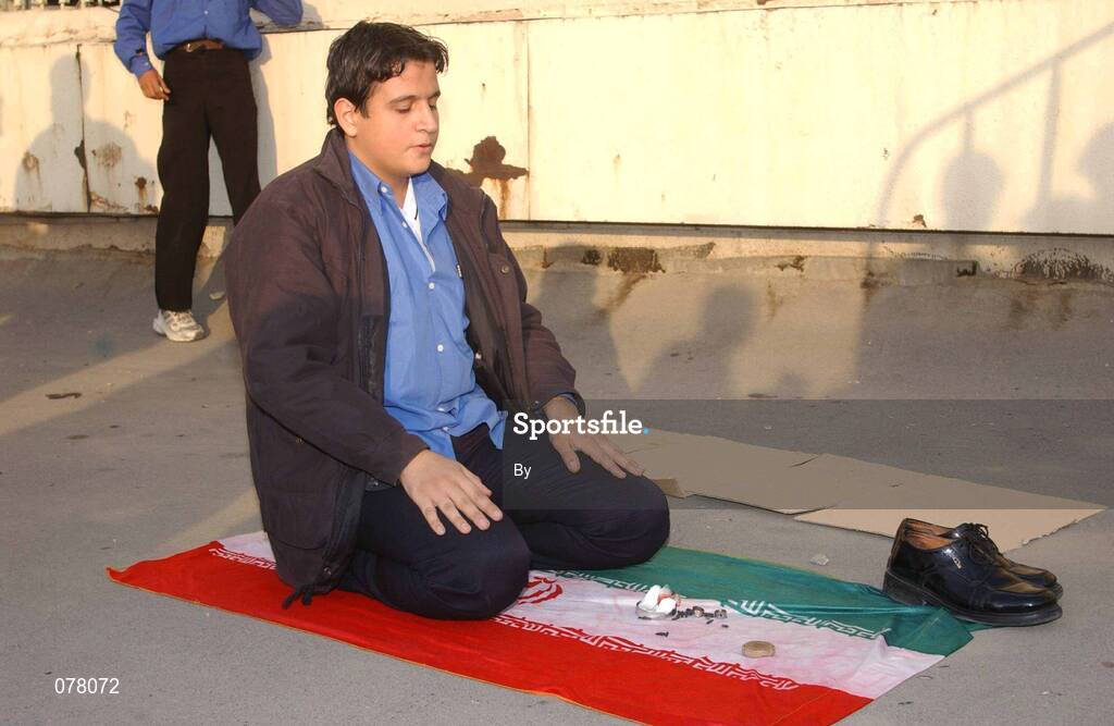 14 November 2001; An Iranian fan prays before the game. Iran v Republic of Ireland, World Cup Play off 2nd leg, Azadi Stadium, Tehran, Iran. Soccer. Picture credit; David Maher / SPORTSFILE *EDI*