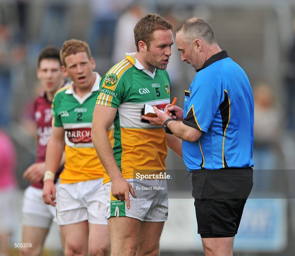 10 April 2011; Referee Martin Sludden books Shane Sullivan, Offaly, during the closing stages of the game. Allianz Football League, Division 2, Round 7, Westmeath v Offaly, Cusack Park, Mullingar, Co. Westmeath. Picture credit: David Maher / SPORTSFILE