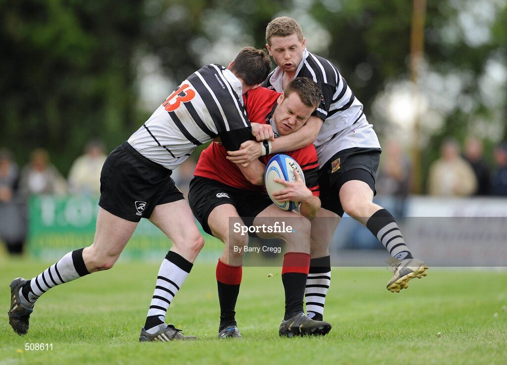 24 April 2011; Colin Hughes, Tullamore RFC, is tackled by Chris Scully and Stephen Murphy, right, Dundalk RFC. Newstalk Provincial Towns Cup Final, Dundalk RFC v Tullamore RFC, Edenderry RFC, Coolavacoose, Carbury, Co. Kildare. Picture credit: Barry Cregg / SPORTSFILE