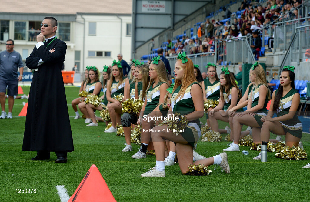 2 September 2016; Fr Augustine Tran, Blessed Trinity staff team member, and the team's cheerleaders look on during their game against St. Peters Prep. Donnybrook Stadium hosted a triple-header of high school American football games today as part of the Aer Lingus College Football Classic. Six top high school teams took part in the American Football Showcase with all proceeds from the game going to Special Olympics Ireland, the official charity partner to the Aer Lingus College Football Classic. High School American Football Showcase match between Blessed Trinity of Atlanta, Georgia and St. Peters Prep of Jersey City, New Jersey at Donnybrook Stadium in Dublin. Photo by Piaras Ó Mídheach/Sportsfile