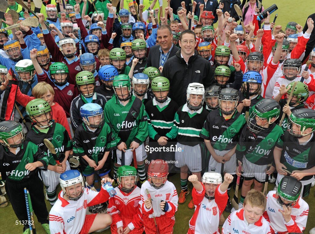 10 May 2011; Dublin National Hurling League winner Liam Ryan marks the beginning of 'Camán Let’s Play', a hurling initiative organised by Parnell’s GAA Club to promote hurling and encourage participation among local Dublin schools. With over 220 children, ranging from 7yrs – 12yrs due to take part, the competition will be based on a round robin series of games, supported by eFlow and at no expense to the participating schools. Pictured at the launch is Liam Ryan, centre right, and Simon McBeth, eFlow, centre left, with participating children. Launch of 'Camán Let’s Play', supported by eFlow, Astro Park, Coolock, Dublin. Picture credit: Brian Lawless / SPORTSFILE