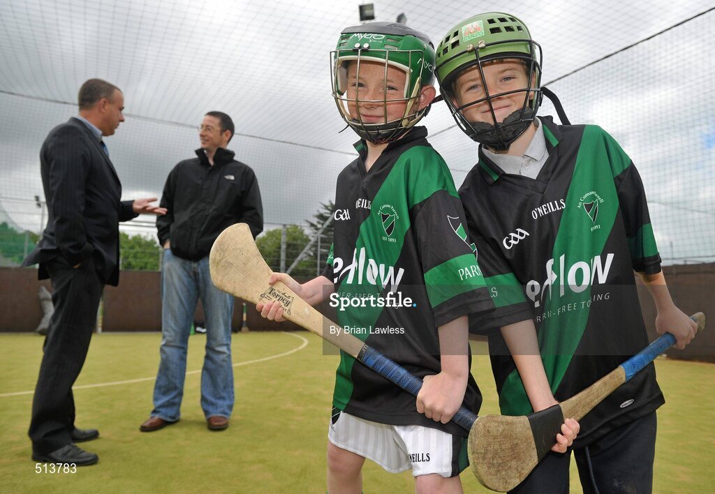 10 May 2011; Dublin National Hurling League winner Liam Ryan marks the beginning of 'Camán Let’s Play', a hurling initiative organised by Parnell’s GAA Club to promote hurling and encourage participation among local Dublin schools. With over 220 children, ranging from 7yrs – 12yrs due to take part, the competition will be based on a round robin series of games, supported by eFlow and at no expense to the participating schools. Pictured at the launch are pupils of Scoil Fhursa, Kilmore West, Adam Ives, age 9, from Coolock, right, and Dylan Doherty, age 9, from Coolock, with Simon McBeth, eFlow, left, and Liam Ryan. Launch of 'Camán Let’s Play', supported by eFlow, Astro Park, Coolock, Dublin. Picture credit: Brian Lawless / SPORTSFILE