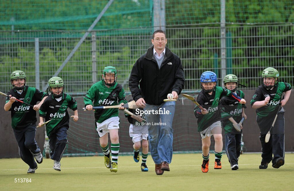 10 May 2011; Dublin National Hurling League winner Liam Ryan marks the beginning of 'Camán Let’s Play', a hurling initiative organised by Parnell’s GAA Club to promote hurling and encourage participation among local Dublin schools. With over 220 children, ranging from 7yrs – 12yrs due to take part, the competition will be based on a round robin series of games, supported by eFlow and at no expense to the participating schools. Pictured at the launch is Liam Ryan with pupils from Scoil Fhursa, Kilmore West. Launch of 'Camán Let’s Play', supported by eFlow, Astro Park, Coolock, Dublin. Picture credit: Brian Lawless / SPORTSFILE