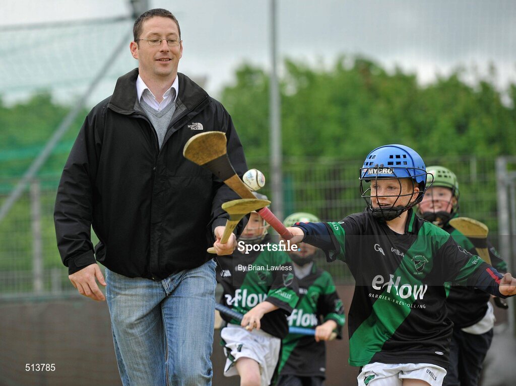 10 May 2011; Dublin National Hurling League winner Liam Ryan marks the beginning of 'Camán Let’s Play', a hurling initiative organised by Parnell’s GAA Club to promote hurling and encourage participation among local Dublin schools. With over 220 children, ranging from 7yrs – 12yrs due to take part, the competition will be based on a round robin series of games, supported by eFlow and at no expense to the participating schools. Pictured at the launch is Liam Ryan with Scoil Fhursa, Kilmore West, pupil Ciaran Cranitch, age 9, from Coolock. Launch of 'Camán Let’s Play', supported by eFlow, Astro Park, Coolock, Dublin. Picture credit: Brian Lawless / SPORTSFILE