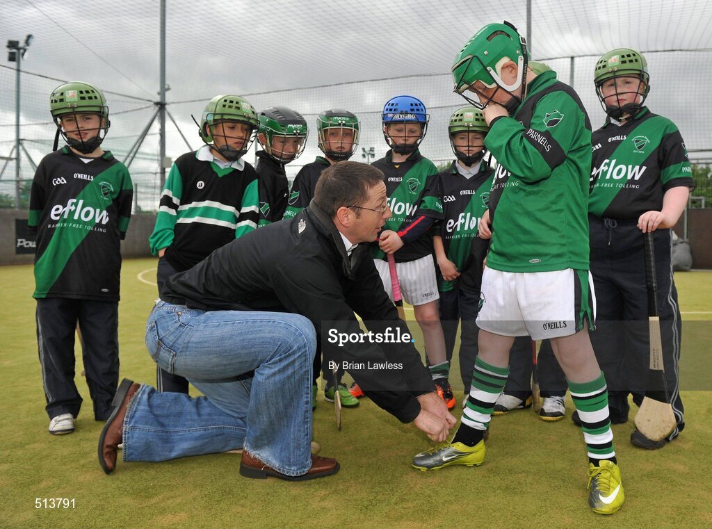 10 May 2011; Dublin National Hurling League winner Liam Ryan marks the beginning of 'Camán Let’s Play', a hurling initiative organised by Parnell’s GAA Club to promote hurling and encourage participation among local Dublin schools. With over 220 children, ranging from 7yrs – 12yrs due to take part, the competition will be based on a round robin series of games, supported by eFlow and at no expense to the participating schools. Pictured at the launch is Liam Ryan with Tony Cranitch, age 9, from Coolock, and pupils from Scoil Fhursa, Kilmore West. Launch of 'Camán Let’s Play', supported by eFlow, Astro Park, Coolock, Dublin. Picture credit: Brian Lawless / SPORTSFILE