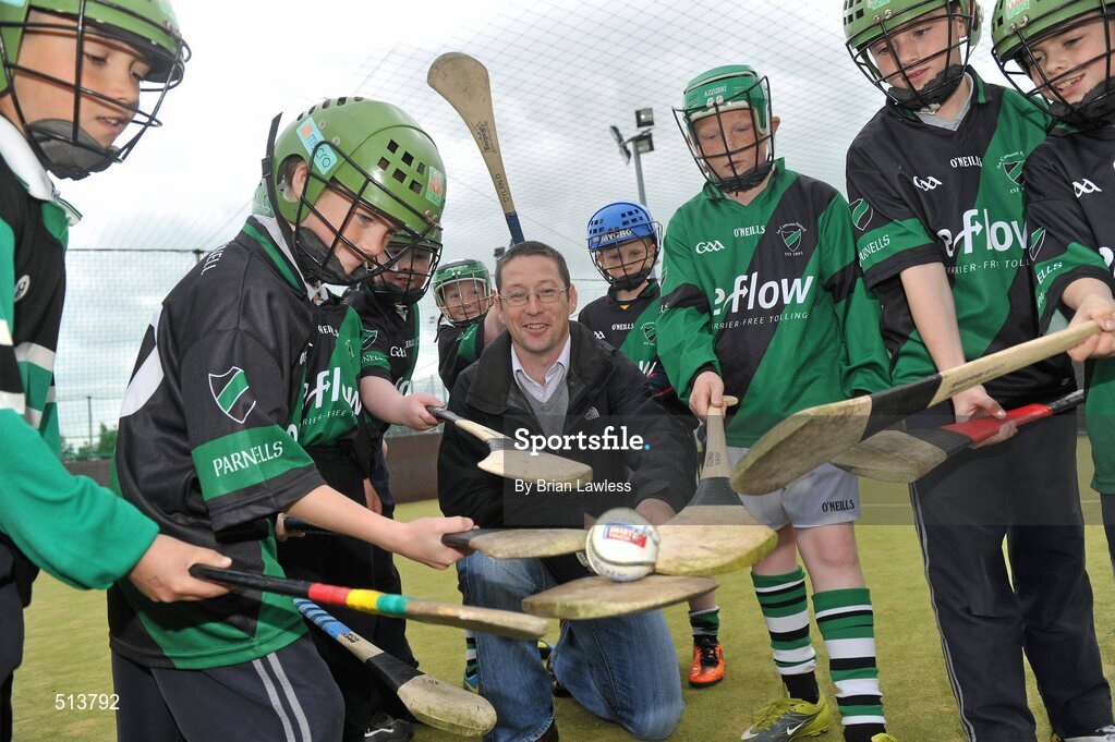10 May 2011; Dublin National Hurling League winner Liam Ryan marks the beginning of 'Camán Let’s Play', a hurling initiative organised by Parnell’s GAA Club to promote hurling and encourage participation among local Dublin schools. With over 220 children, ranging from 7yrs – 12yrs due to take part, the competition will be based on a round robin series of games, supported by eFlow and at no expense to the participating schools. Pictured at the launch is Liam Ryan with pupils from Scoil Fhursa, Kilmore West. Launch of 'Camán Let’s Play', supported by eFlow, Astro Park, Coolock, Dublin. Picture credit: Brian Lawless / SPORTSFILE