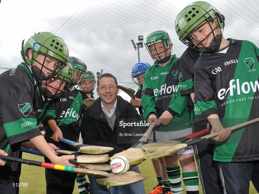 10 May 2011; Dublin National Hurling League winner Liam Ryan marks the beginning of 'Camán Let’s Play', a hurling initiative organised by Parnell’s GAA Club to promote hurling and encourage participation among local Dublin schools. With over 220 children, ranging from 7yrs – 12yrs due to take part, the competition will be based on a round robin series of games, supported by eFlow and at no expense to the participating schools. Pictured at the launch is Liam Ryan with pupils from Scoil Fhursa, Kilmore West. Launch of 'Camán Let’s Play', supported by eFlow, Astro Park, Coolock, Dublin. Picture credit: Brian Lawless / SPORTSFILE