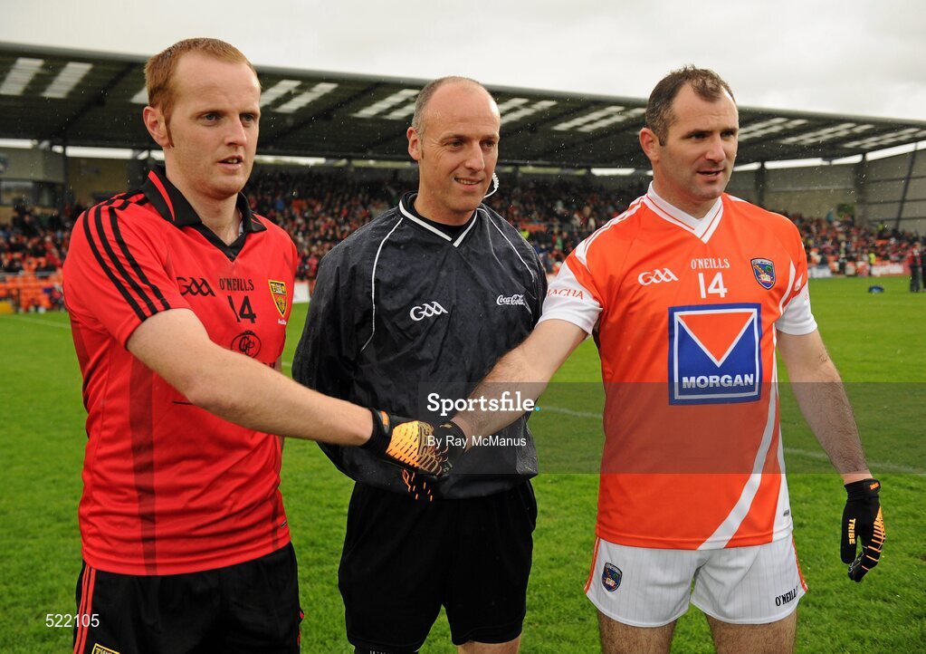 28 May 2011; Steven McDonnell, the Armagh captain, and Brendan Coulter, the Down captain, shake hands accross referee Cormac Reilly before the game. Ulster GAA Football Senior Championship Quarter-Final, Armagh v Down, Morgan Athletic Grounds, Armagh. Picture credit: Ray McManus / SPORTSFILE
