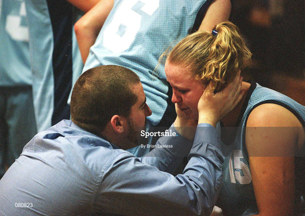 25 January 2002; Mercy Coolock's Jessica Collins is consoled by a team official after defeat to Dart Killester in the ESB Women's National Cup Semi-Final between Mercy Coolock and Dart Killester at the ESB Arena in Tallaght, Dublin. Photo by Brian Lawless/Sportsfile
