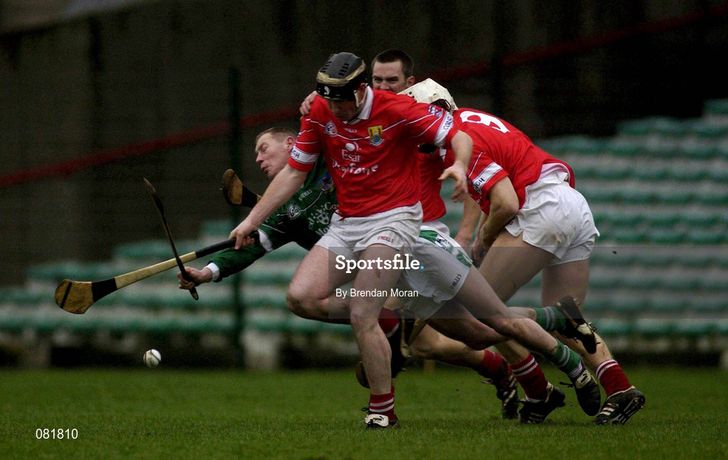 25 February 2002; Ciaran Carey of Limerick, is tackled by Mark Landers, wearing a black helmet, and Timmy McCarthy, both of Cork, during the Allianz National Hurling League Division 1B Round 1 match between Limerick and Cork at the Gaelic Grounds in Limerick. Photo by Brendan Moran/Sportsfile