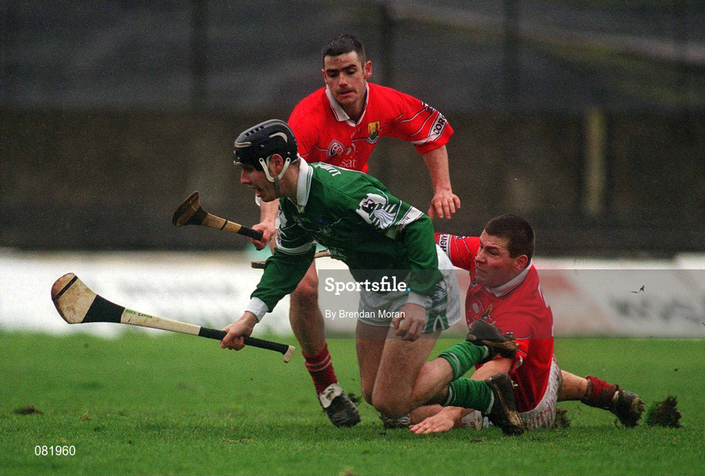 25 February 2002; Mark Keane of Limerick, in action against Diarmuid O'Sullivan, grounded, and Mark Prendergast of Cork during the Allianz National Hurling League Division 1B Round 1 match between Limerick and Cork at the Gaelic Grounds in Limerick. Photo by Brendan Moran/Sportsfile