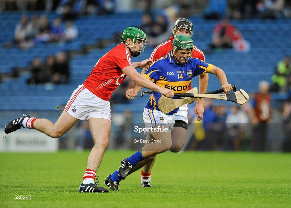15 July 2011; John O'Neill, Tipperary, in action against William Egan, left, and Mark Ellis, right, Cork. Bord Gáis Energy Munster GAA Hurling Under 21 Championship Semi-Final, Tipperary v Cork, Semple Stadium, Thurles, Co. Tipperary. Picture credit: Barry Cregg / SPORTSFILE