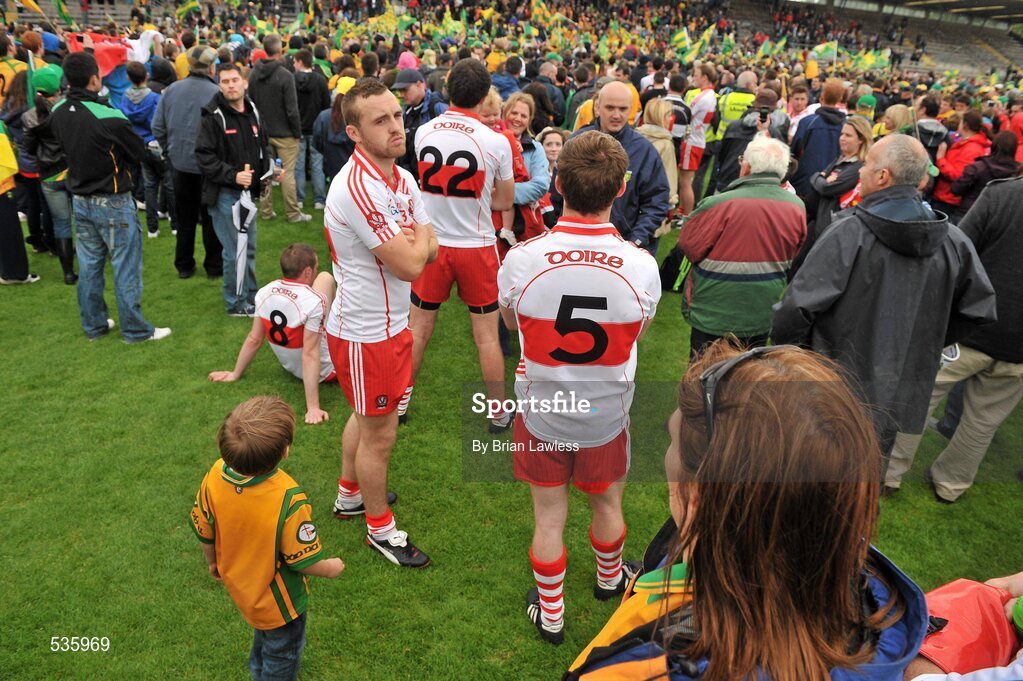 17 July 2011; Emmett McGuckin, Derry, turns away as Donegal players celebrate with the cup. Ulster GAA Football Senior Championship Final, Derry v Donegal, St Tiernach's Park, Clones, Co. Monaghan. Picture credit: Brian Lawless / SPORTSFILE