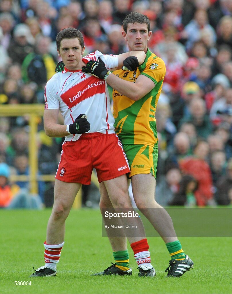 17 July 2011; Dermot McBride, Derry, tangles with Patrick McBrearty, Donegal, after Donegal had scored their goal from a penalty. McBride was subsequently shown a yellow card. Ulster GAA Football Senior Championship Final, Derry v Donegal, St Tiernach's Park, Clones, Co. Monaghan. Picture credit: Michael Cullen / SPORTSFILE
