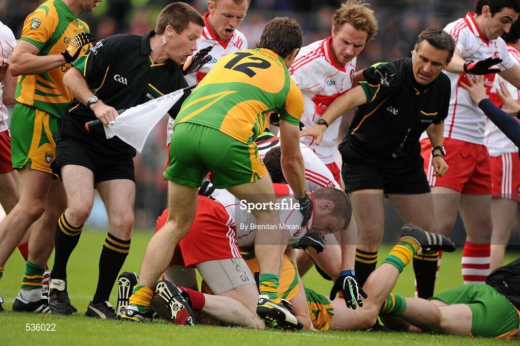 17 July 2011; Linesman Padraig Hughes and referee Maurice Deegan attempt to separate players from both sides during the second half. Ulster GAA Football Senior Championship Final, Derry v Donegal, St Tiernach's Park, Clones, Co. Monaghan. Picture credit: Brendan Moran / SPORTSFILE