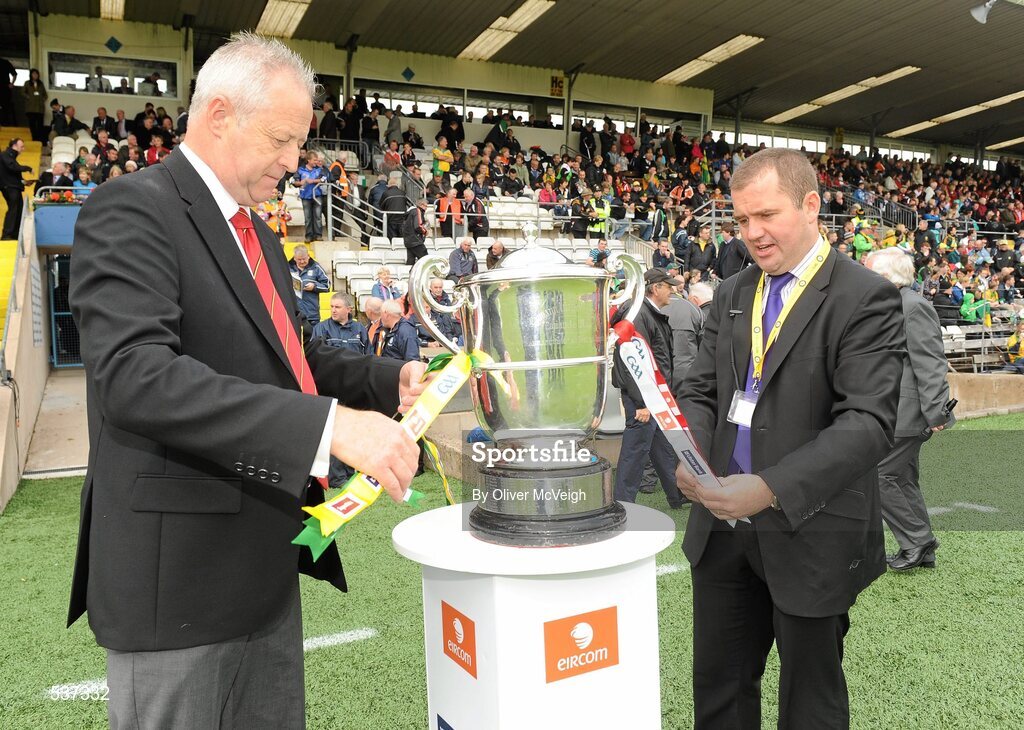 17 July 2011; Martin McAviney, vice President Ulster GAA and Stephen McGeehan, Operations manager Ulster GAA, tie the ribbons from both teams on the cup before the game. Ulster GAA Football Senior Championship Final, Derry v Donegal, St Tiernach's Park, Clones, Co. Monaghan. Picture credit: Oliver McVeigh / SPORTSFILE