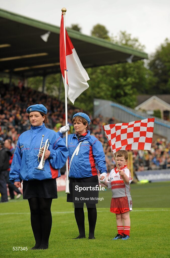 17 July 2011;  Derry mascot four year Donal O'Connor along with his mother Moira O'Connor, a flag bearer with St. Michael's Scout Brass Band Enniskillen, before the game. Ulster GAA Football Senior Championship Final, Derry v Donegal, St Tiernach's Park, Clones, Co. Monaghan. Picture credit: Oliver McVeigh / SPORTSFILE