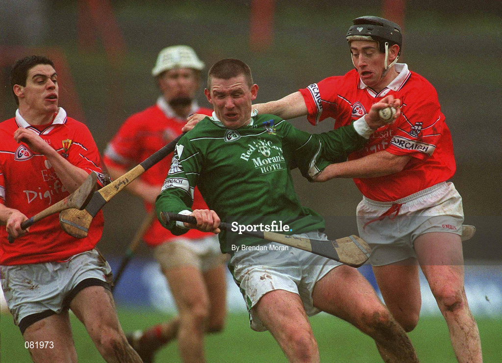25 February 2002; Mark Foley of Limerick in action against Cork's Neil Ronan, left, and Pat Ryan during the Allianz National Hurling League Division 1B Round 1 match between Limerick and Cork at the Gaelic Grounds in Limerick. Photo by Brendan Moran/Sportsfile