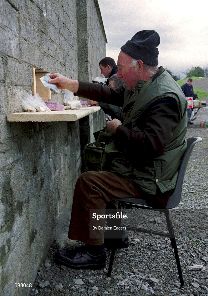 2 March 2002; A Ticket seller dispenses tickets prior to the AIB GAA Football All-Ireland Senior Club Championship Semi-Final match between Nemo Rangers and Charlestown Sarsfield at McDonagh Park in Nenagh, Tipperary. Photo by Damien Eagers/Sportsfile