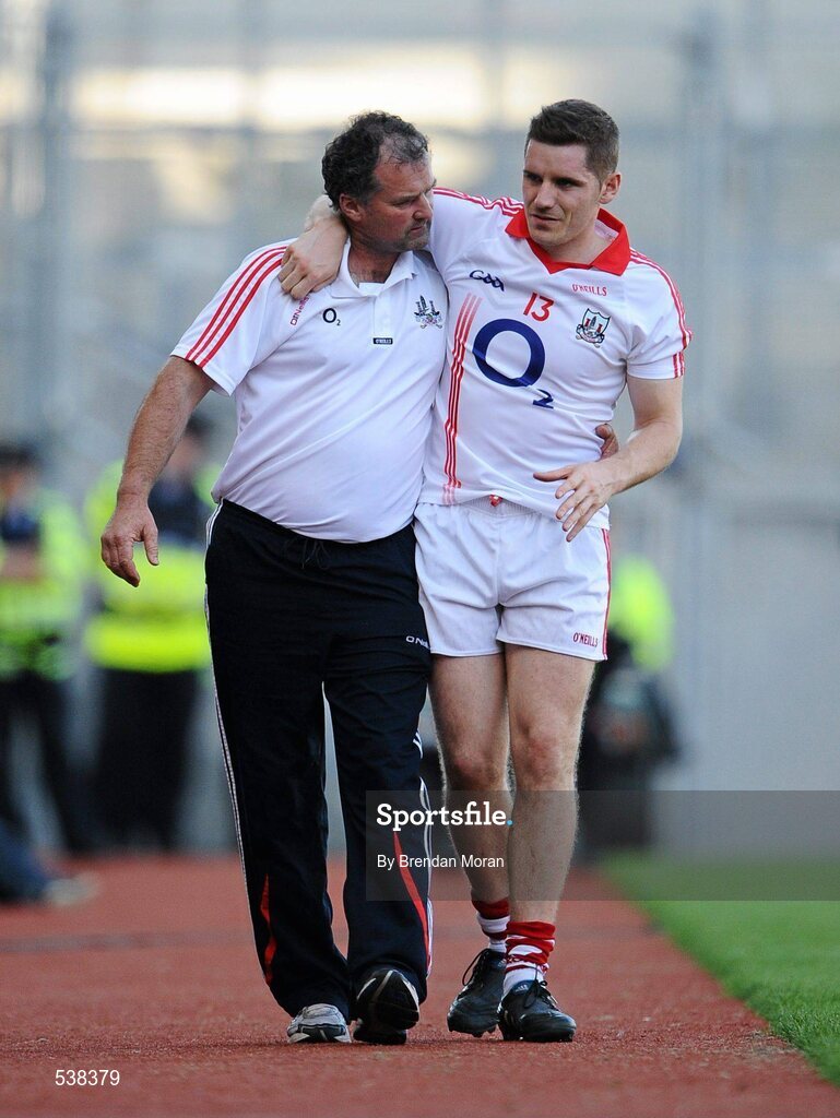 23 July 2011; Daniel Goulding, Cork, is escorted from the pitch during the first half with a leg injury. GAA Football All-Ireland Senior Championship Qualifier Round 4, Cork v Down, Croke Park, Dublin. Picture credit: Brendan Moran / SPORTSFILE