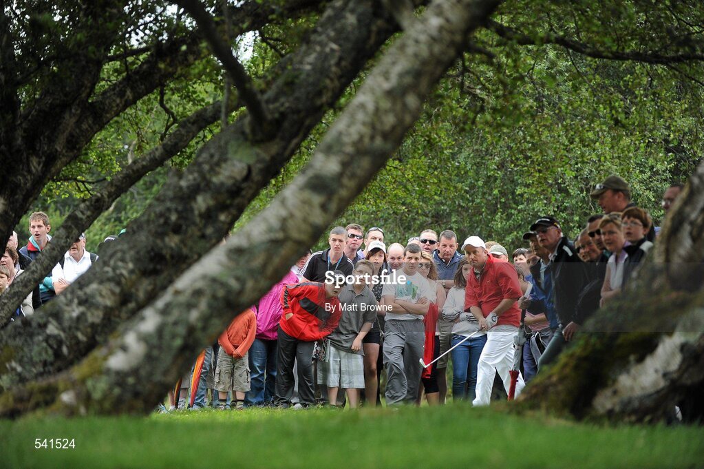 30 July 2011; Damien McGrane watches his second shot from under the trees off the 4th fairway during the third round of the 2011 Discover Ireland Irish Open Golf Championship, Killarney Golf & Fishing Club, Killarney, Co. Kerry. Picture credit: Matt Browne / SPORTSFILE